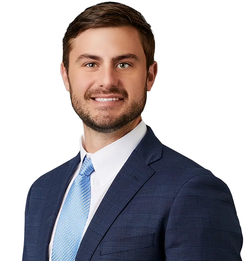 a man wearing a suit and tie smiling at the camera